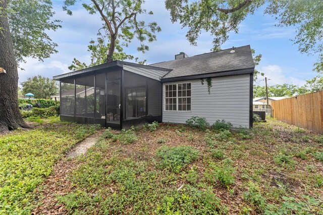 2313 Palm Ave, Seffner, FL 33584 - back of house featuring a sunroom and a chimney