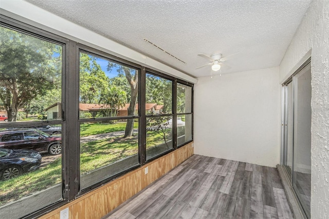 2770 Keats Ter Unit C, Palm Harbor, FL 34684 - unfurnished sunroom featuring a textured ceiling, a ceiling fan, plenty of natural light, and wood finished floors