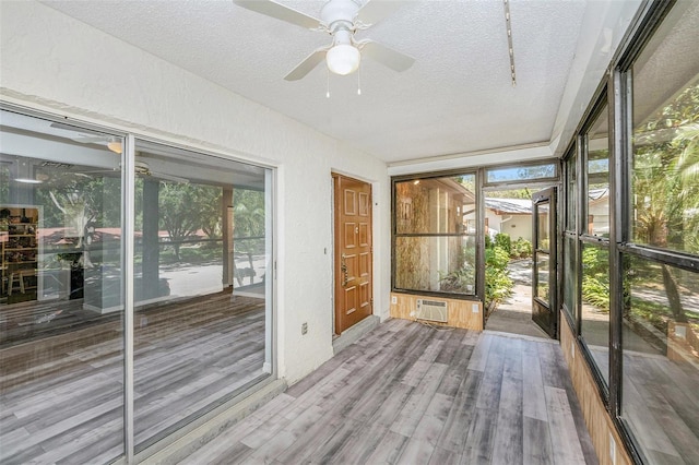 2770 Keats Ter Unit C, Palm Harbor, FL 34684 - unfurnished sunroom with a wall unit AC, a ceiling fan, and plenty of natural light
