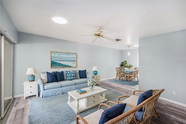 2770 Keats Ter Unit C, Palm Harbor, FL 34684 - living area featuring wood finished floors, baseboards, and ceiling fan