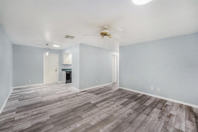 2770 Keats Ter Unit C, Palm Harbor, FL 34684 - empty room featuring a ceiling fan, light wood-type flooring, and baseboards