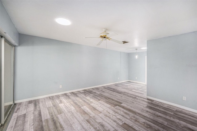 2770 Keats Ter Unit C, Palm Harbor, FL 34684 - empty room featuring wood finished floors, ceiling fan, and baseboards