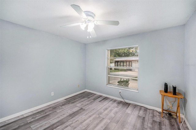 2770 Keats Ter Unit C, Palm Harbor, FL 34684 - spare room with wood finished floors, ceiling fan, and baseboards
