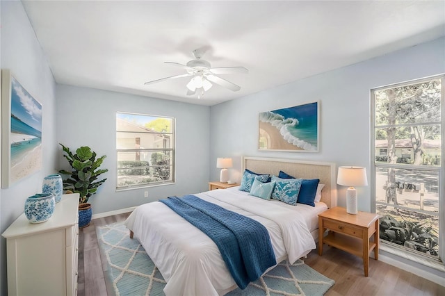 2770 Keats Ter Unit C, Palm Harbor, FL 34684 - bedroom featuring multiple windows, wood finished floors, and ceiling fan