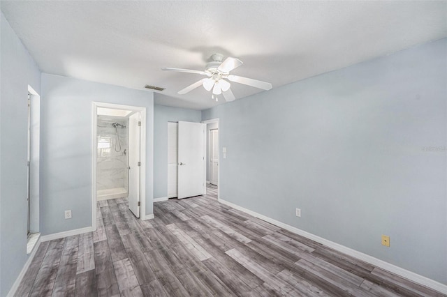 2770 Keats Ter Unit C, Palm Harbor, FL 34684 - unfurnished bedroom with wood finished floors, baseboards, a ceiling fan, and ensuite bathroom