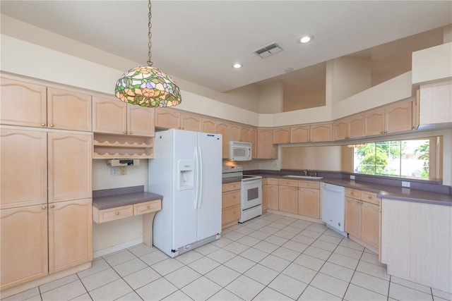 1126 Haley Ln, Dunedin, FL 34698 - kitchen featuring white appliances, light brown cabinets, a sink, dark countertops, and recessed lighting