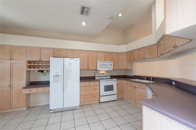 1126 Haley Ln, Dunedin, FL 34698 - kitchen with white appliances, light brown cabinets, a sink, dark countertops, and recessed lighting
