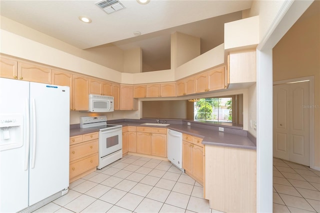 1126 Haley Ln, Dunedin, FL 34698 - kitchen with white appliances, light brown cabinetry, light tile patterned floors, a sink, and a high ceiling