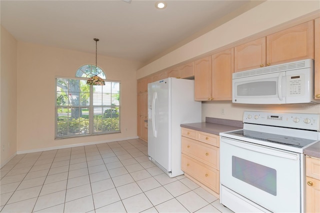 1126 Haley Ln, Dunedin, FL 34698 - kitchen with white appliances, light brown cabinetry, pendant lighting, dark countertops, and vaulted ceiling