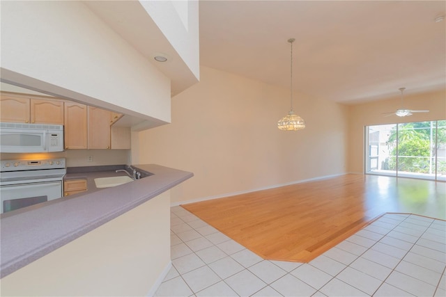 1126 Haley Ln, Dunedin, FL 34698 - kitchen featuring white appliances, light brown cabinets, open floor plan, light tile patterned flooring, and a sink