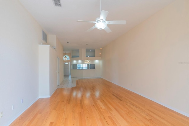 1126 Haley Ln, Dunedin, FL 34698 - unfurnished living room featuring wood finished floors, ceiling fan, and baseboards