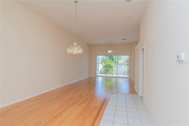 1126 Haley Ln, Dunedin, FL 34698 - spare room with light wood finished floors, ceiling fan, and baseboards