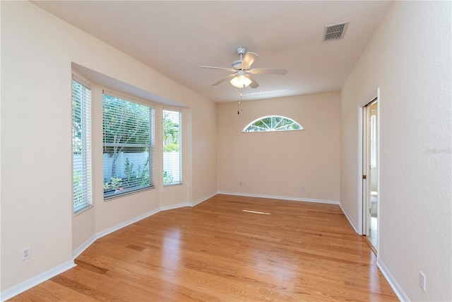 1126 Haley Ln, Dunedin, FL 34698 - unfurnished room with light wood finished floors, a ceiling fan, and baseboards