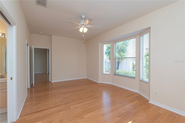 1126 Haley Ln, Dunedin, FL 34698 - empty room with ceiling fan, light wood-type flooring, and baseboards