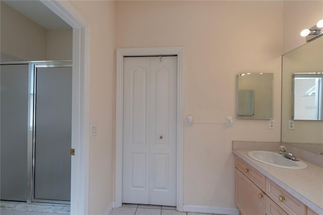 1126 Haley Ln, Dunedin, FL 34698 - full bath with vanity, a shower stall, a closet, baseboards, and tile patterned flooring