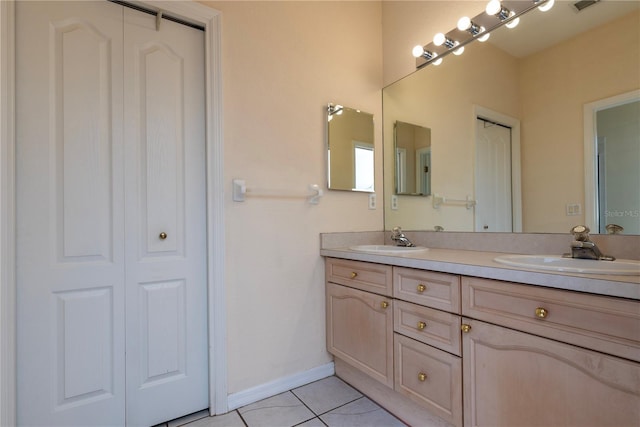 1126 Haley Ln, Dunedin, FL 34698 - full bath with double vanity, tile patterned floors, a closet, and baseboards