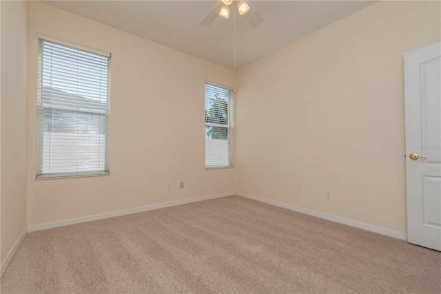 1126 Haley Ln, Dunedin, FL 34698 - empty room featuring light carpet, a ceiling fan, and baseboards