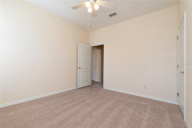 1126 Haley Ln, Dunedin, FL 34698 - empty room featuring light colored carpet, a ceiling fan, and baseboards