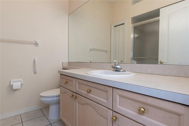 1126 Haley Ln, Dunedin, FL 34698 - full bath featuring tile patterned flooring, vanity, toilet, a shower stall, and baseboards