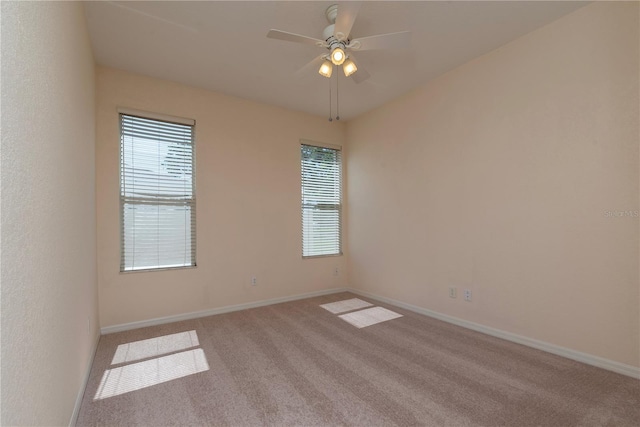 1126 Haley Ln, Dunedin, FL 34698 - spare room featuring carpet floors, healthy amount of natural light, baseboards, and ceiling fan