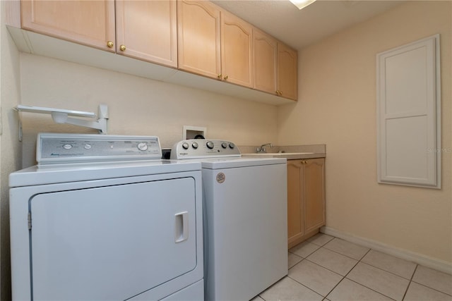 1126 Haley Ln, Dunedin, FL 34698 - laundry room featuring washing machine and clothes dryer, cabinet space, baseboards, and light tile patterned floors