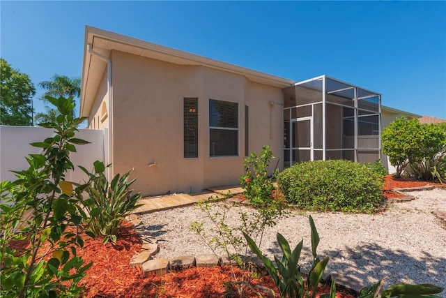 1126 Haley Ln, Dunedin, FL 34698 - back of property featuring stucco siding and glass enclosure