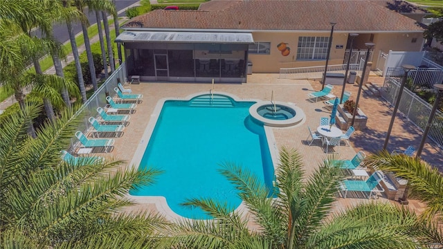 1126 Haley Ln, Dunedin, FL 34698 - view of swimming pool featuring a patio, a fenced backyard, a sunroom, and a pool with connected hot tub
