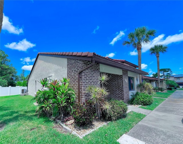 7360 Ulmerton Rd Unit 16A, Largo, FL 33771 - view of side of property with brick siding, a tile roof, and stucco siding
