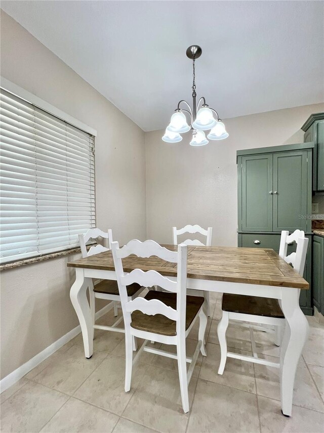 7360 Ulmerton Rd Unit 16A, Largo, FL 33771 - dining area with a chandelier, baseboards, and light tile patterned floors