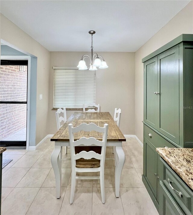 7360 Ulmerton Rd Unit 16A, Largo, FL 33771 - dining space featuring a chandelier, light tile patterned flooring, and baseboards