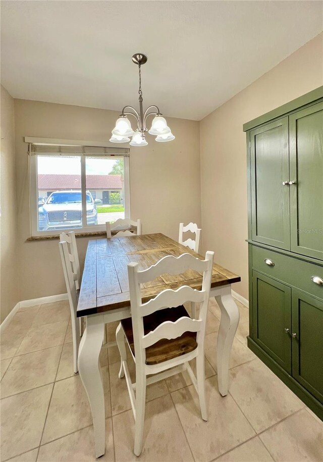 7360 Ulmerton Rd Unit 16A, Largo, FL 33771 - dining space featuring light tile patterned floors, baseboards, and a chandelier