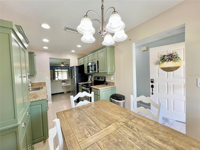 7360 Ulmerton Rd Unit 16A, Largo, FL 33771 - kitchen with green cabinets, stainless steel appliances, a chandelier, light tile patterned floors, and recessed lighting