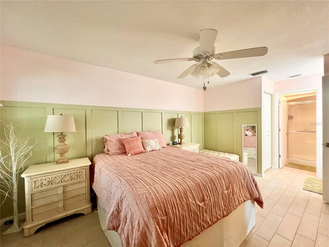 7360 Ulmerton Rd Unit 16A, Largo, FL 33771 - bedroom featuring a decorative wall, wainscoting, and a ceiling fan