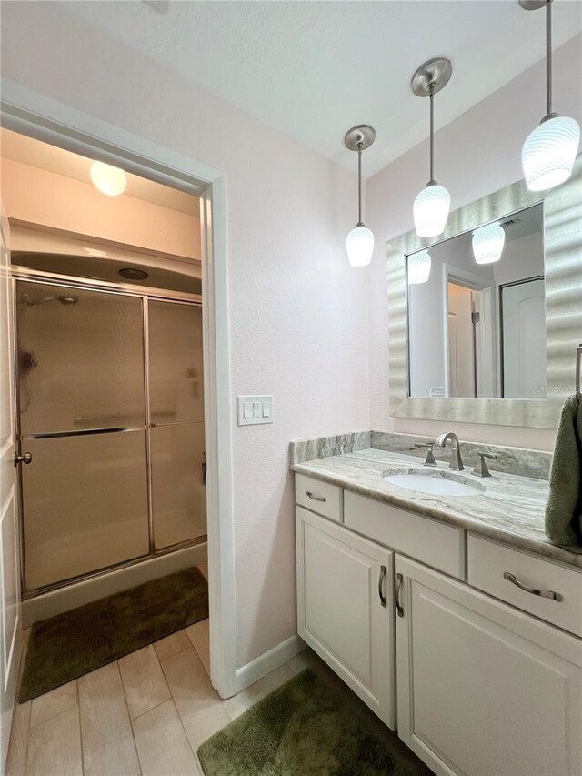 7360 Ulmerton Rd Unit 16A, Largo, FL 33771 - full bathroom with a stall shower, vanity, tile patterned flooring, and baseboards