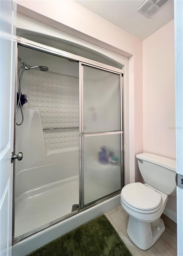 7360 Ulmerton Rd Unit 16A, Largo, FL 33771 - full bathroom featuring a stall shower, toilet, and tile patterned floors