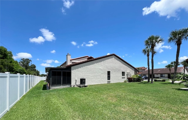 7360 Ulmerton Rd Unit 16A, Largo, FL 33771 - rear view of house with a chimney, a sunroom, stucco siding, and central AC unit