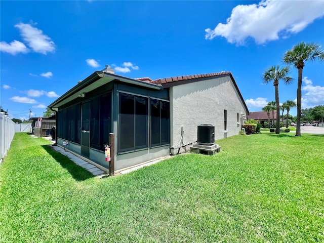 7360 Ulmerton Rd Unit 16A, Largo, FL 33771 - view of property exterior with a sunroom, stucco siding, a tile roof, and central AC