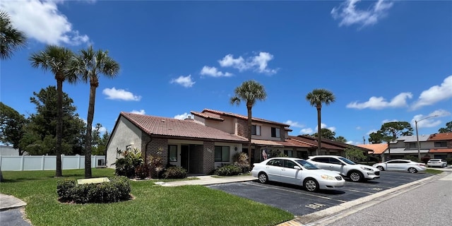 7360 Ulmerton Rd Unit 16A, Largo, FL 33771 - view of front of home with a tiled roof, uncovered parking, and stucco siding