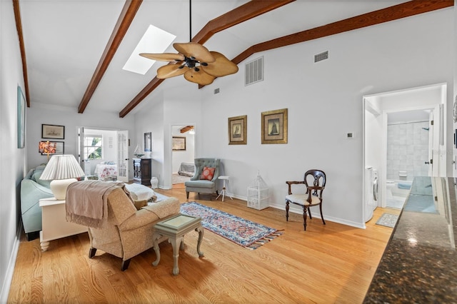 2665 Sequoia Ter Unit 306, Palm Harbor, FL 34683 - living room with ceiling fan, beam ceiling, light wood-style floors, baseboards, and a skylight