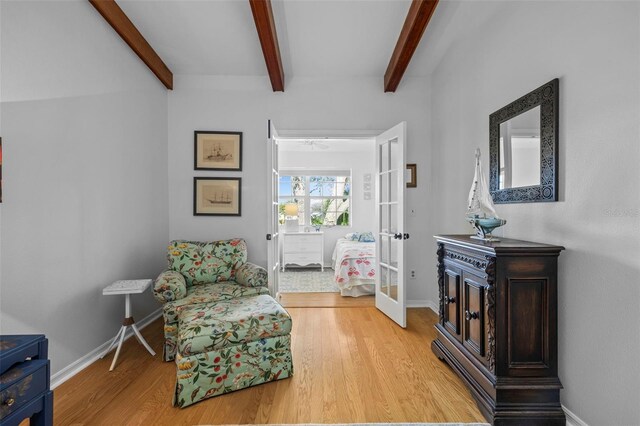 2665 Sequoia Ter Unit 306, Palm Harbor, FL 34683 - sitting room featuring french doors, beam ceiling, light wood-type flooring, and baseboards