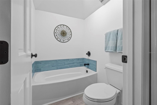 2665 Sequoia Ter Unit 306, Palm Harbor, FL 34683 - bathroom with toilet, a garden tub, and wood finished floors