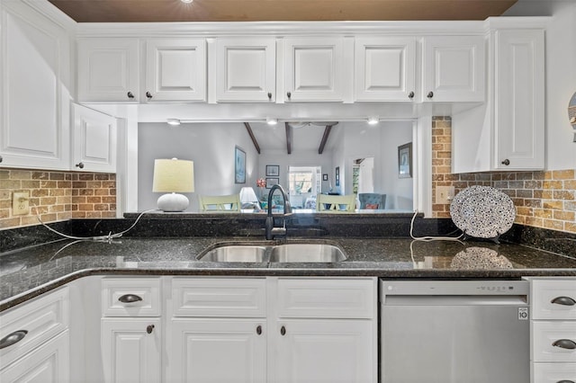 2665 Sequoia Ter Unit 306, Palm Harbor, FL 34683 - kitchen with dishwasher, a sink, white cabinets, and dark stone counters