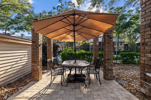2665 Sequoia Ter Unit 306, Palm Harbor, FL 34683 - view of patio / terrace featuring outdoor dining space and fence