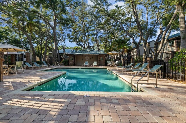 2665 Sequoia Ter Unit 306, Palm Harbor, FL 34683 - community pool featuring a patio, fence, and a residential view