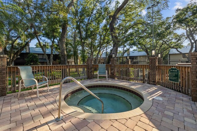 2665 Sequoia Ter Unit 306, Palm Harbor, FL 34683 - view of swimming pool with a hot tub and fence