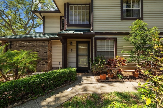 2665 Sequoia Ter Unit 306, Palm Harbor, FL 34683 - entrance to property with a standing seam roof, metal roof, and brick siding