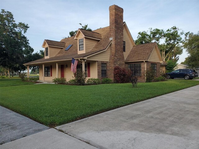 2615 Southern Oaks Pl, Plant City, FL 33566 - view of front of house with a chimney, a front yard, roof with shingles, and brick siding