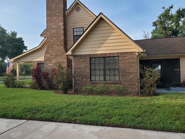 2615 Southern Oaks Pl, Plant City, FL 33566 - view of front of home featuring a chimney, a front lawn, and brick siding