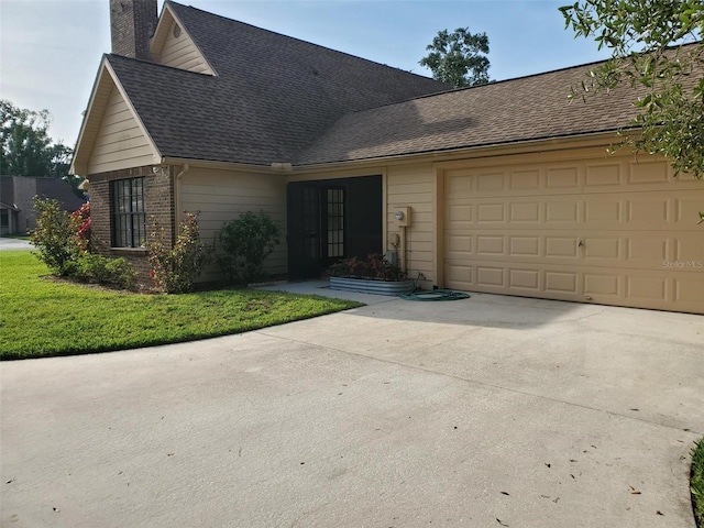 2615 Southern Oaks Pl, Plant City, FL 33566 - view of front of home featuring a garage, a chimney, driveway, a shingled roof, and brick siding