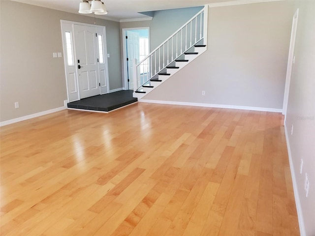 2615 Southern Oaks Pl, Plant City, FL 33566 - entrance foyer with crown molding, light wood-style floors, stairs, and baseboards